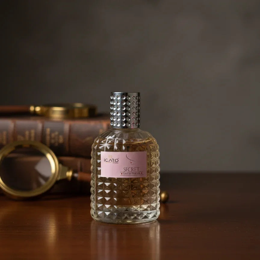 Icaro Secret Eau de Parfum bottle and pink box on wooden table, luxury fragrance display