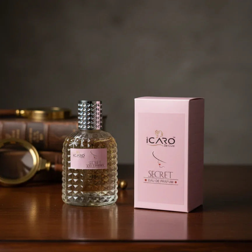 Icaro Secret Eau de Parfum bottle and pink box on wooden table, luxury fragrance display
