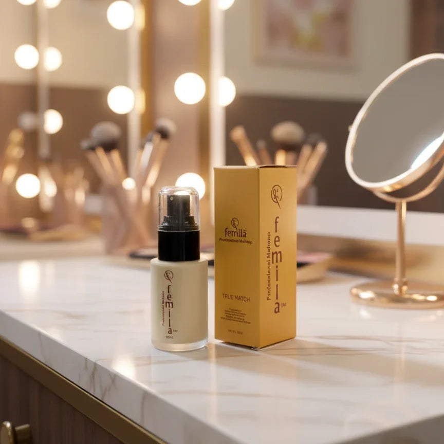 Femilia foundation bottle and box on marble vanity with mirror and makeup brushes