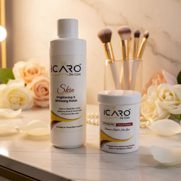 Icaro skin brightening polish and whitening powder on vanity with roses and makeup brushes